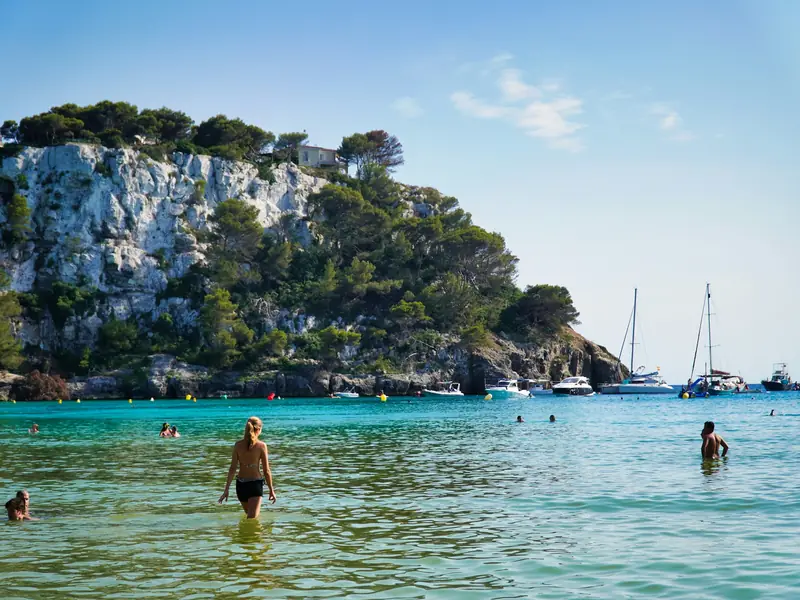People swimming in a turquoise cove